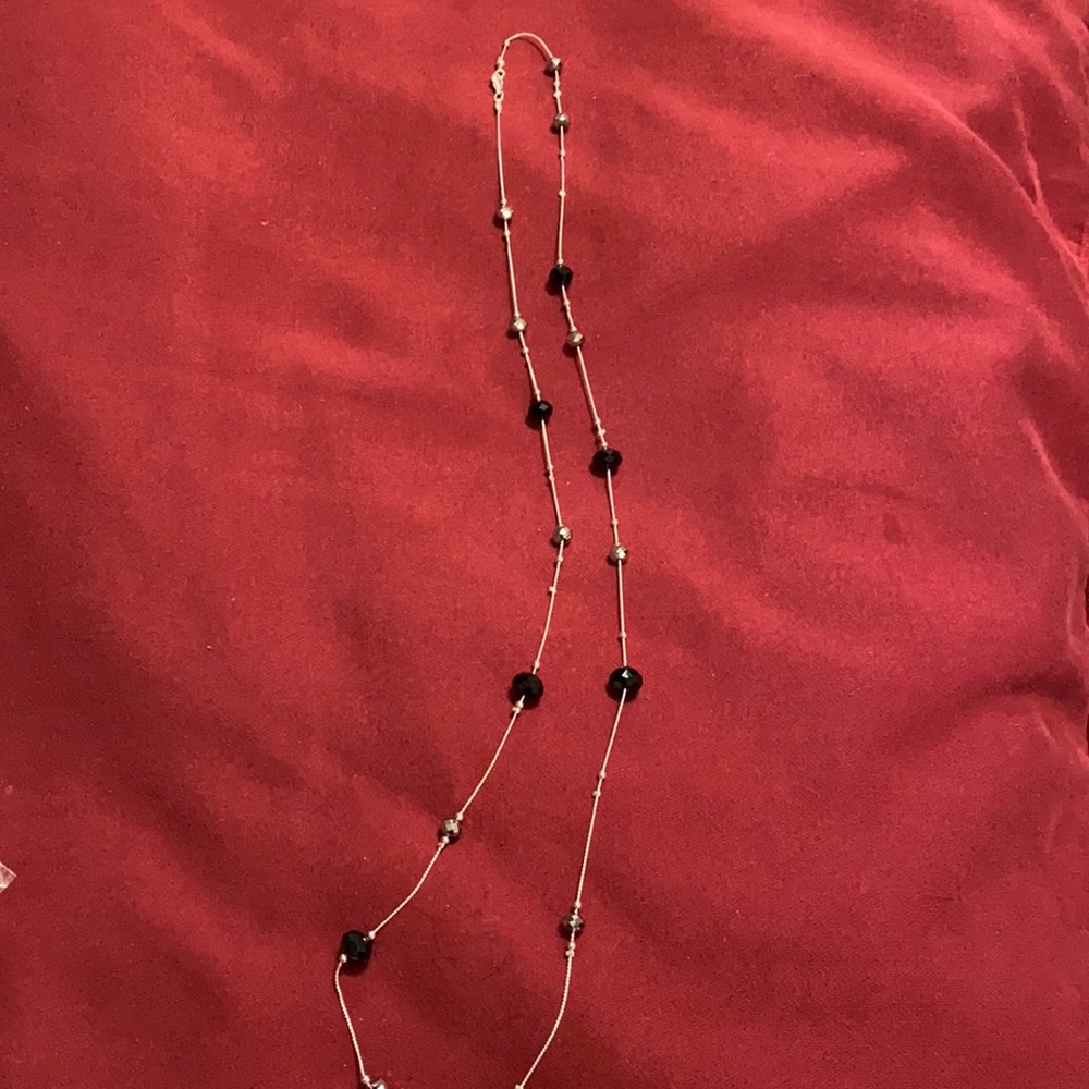 Long silver necklace with black and glass beads